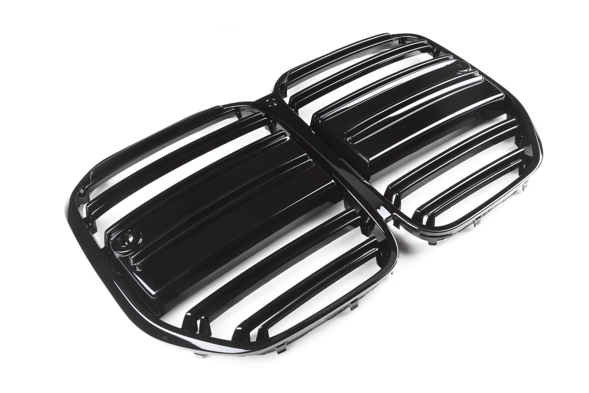 Black, glossy car grille displaying horizontal slats is placed on a plain, white background, suggesting a focus on automotive design and functionality.
