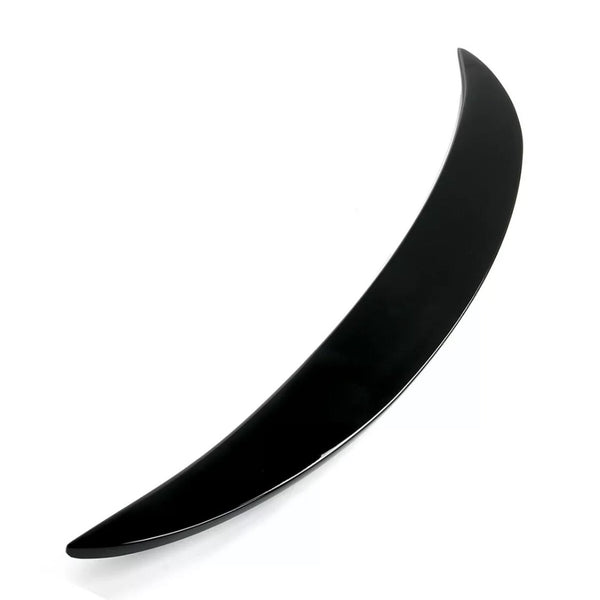 A sleek, black, curved object rests against a white background, resembling a crescent or boomerang shape, suggesting potential for aerodynamic purposes or decorative design.