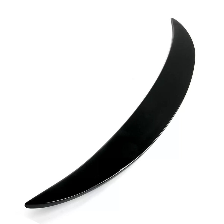 A sleek, black, curved object rests against a white background, resembling a crescent or boomerang shape, suggesting potential for aerodynamic purposes or decorative design.