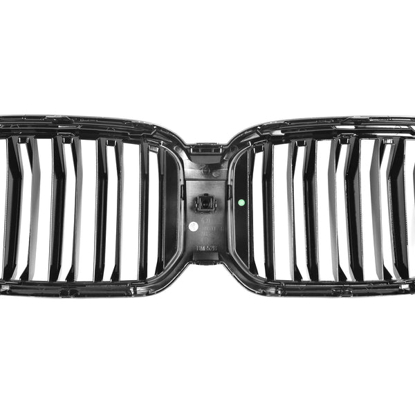 A shiny, black car grille with vertical slats is isolated on a white background. It features a dual-kidney design and has small text and markings visible on the connecting center bar.