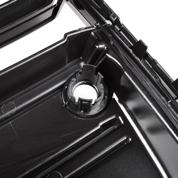 A glossy black plastic automotive part with a circular mount and ridges is shown in close-up, likely part of a larger engine or mechanical assembly.