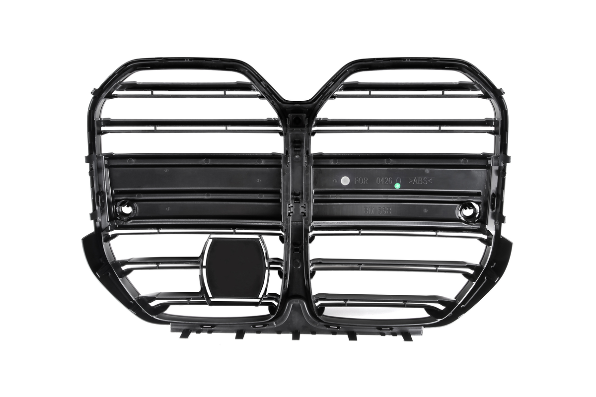 Black vehicle grille with horizontal slats, forming two connected, rounded sections. Molded text on one slat reads "FOR 0426 >ABS< BM 555." Set against a white background.