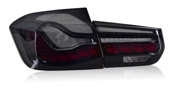 A sleek car taillight, featuring bold red and clear segments, is positioned against a white studio background.