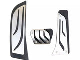 Three metal car pedal covers, featuring sleek black accents and a modern design, are arranged on a plain white background.