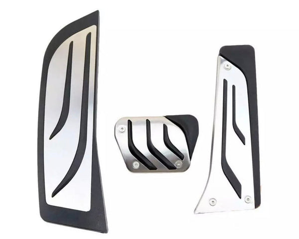 Three metal car pedal covers, featuring sleek black accents and a modern design, are arranged on a plain white background.