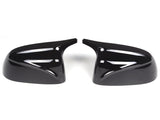 Two glossy black car mirror covers facing each other on a white background, showcasing sleek design and smooth, reflective surfaces.