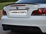 The car's rear features a white BMW 135i, with carbon fiber accents and 