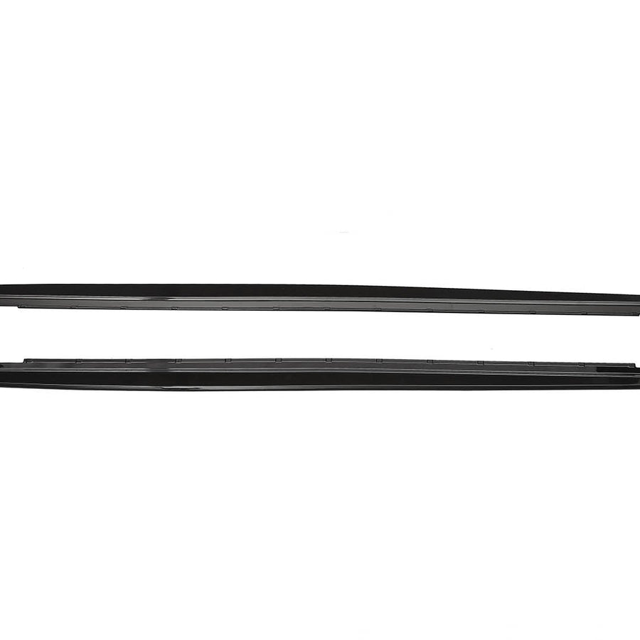 Two sleek, black car side skirts, aligned horizontally, lie against a plain white background, showing their aerodynamic design and smooth edges.