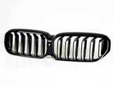 A black, double-kidney-shaped car grille with vertical slats, positioned on a plain white background.