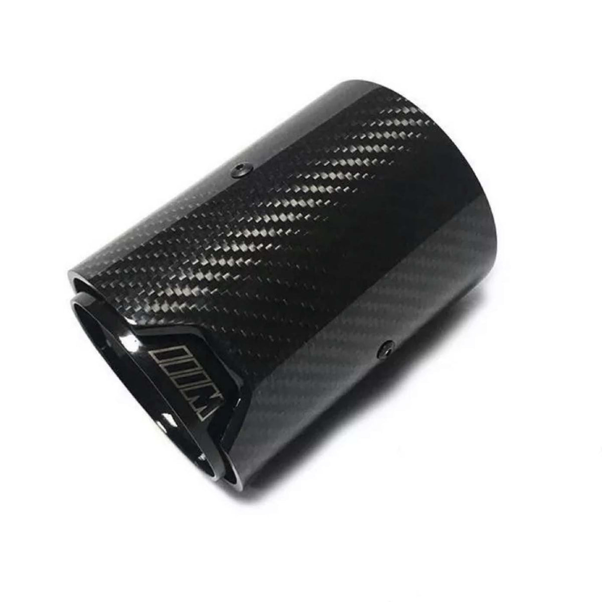 A glossy black carbon fiber exhaust tip lies against a white background, its cylindrical shape adorned with subtle diagonal patterns and screws, featuring an emblem resembling “M” outlined near the edge.