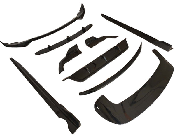 Black automobile body kit components are arranged on a white background. The kit includes various aerodynamic pieces like a front lip and side skirts, designed for vehicle exterior enhancements.