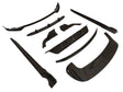 Black automobile body kit components are arranged on a white background. The kit includes various aerodynamic pieces like a front lip and side skirts, designed for vehicle exterior enhancements.