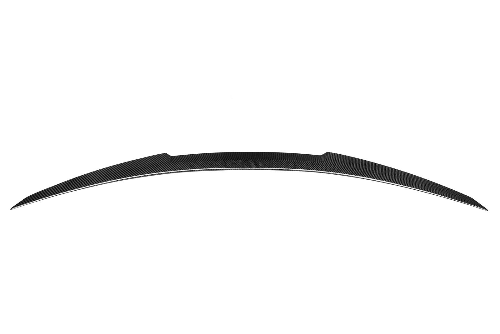 Curved carbon fiber car spoiler resting in a plain white background. The spoiler features a sleek, streamlined design and symmetrical tapering at both ends.