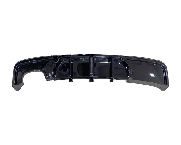 A glossy black car rear diffuser featuring vertical fins is displayed against a plain white background.