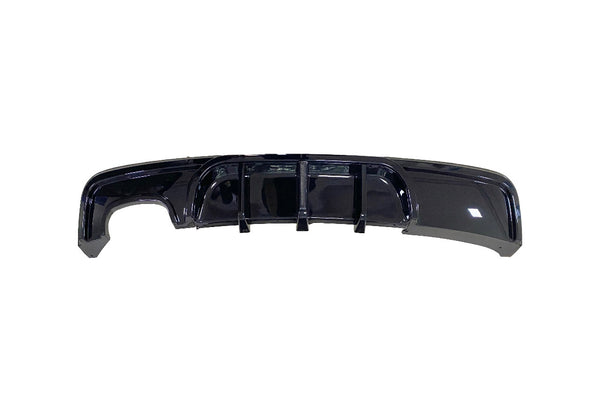 A glossy black car rear diffuser featuring vertical fins is displayed against a plain white background.
