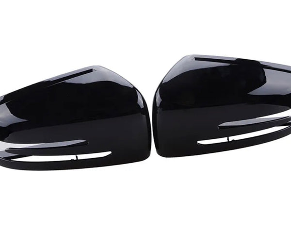 Two identical black plastic car side mirror covers, positioned symmetrically, face each other. They have a glossy finish and are designed to fit over existing mirrors, set against a plain white background.