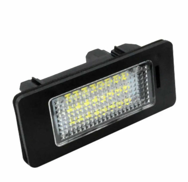 A rectangular LED car light unit is angled slightly upward, featuring a series of yellow LEDs within a textured, transparent panel. The outer casing is black, set against a white background.
