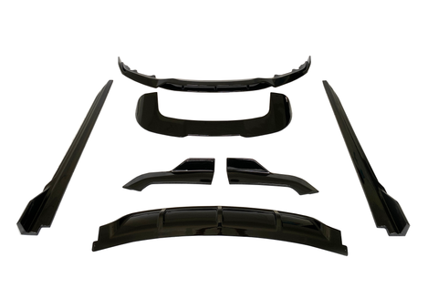 Black car body kit pieces arranged on a white background, including a bumper lip, side skirts, and diffuser parts, all presented symmetrically and evenly spaced.