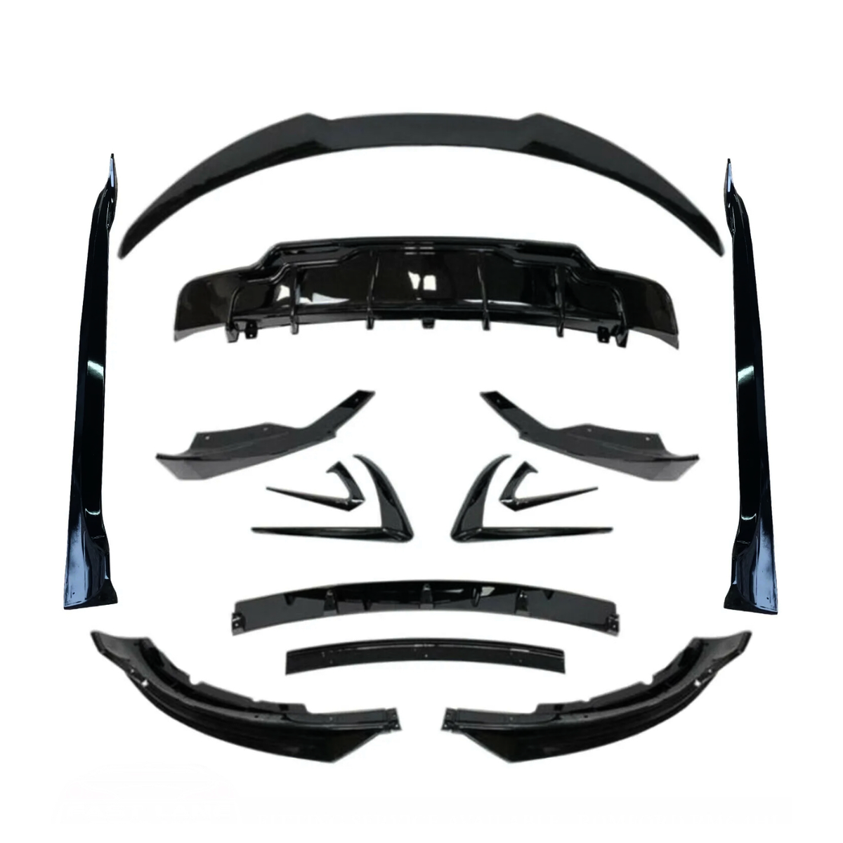 Various black car body kit components, including spoilers and diffusers, arranged symmetrically on a white background, showcasing their design and shape for automotive customization.