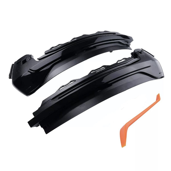 Two black automotive light covers, labeled "ANG RONG," rest near an orange plastic tool on a white background.
