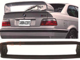 A silver car's rear with a large spoiler and 
