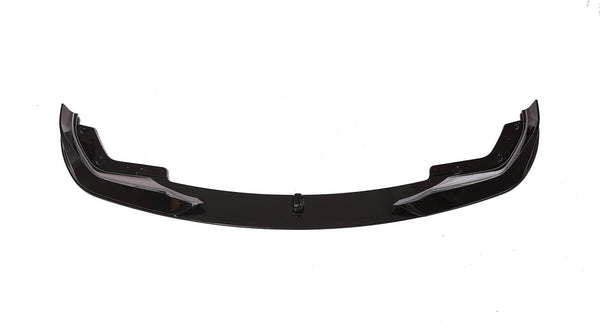 A sleek, black car front lip spoiler, resting on a white background, showcasing its aerodynamic shape with curved ends and bolt fixtures.
