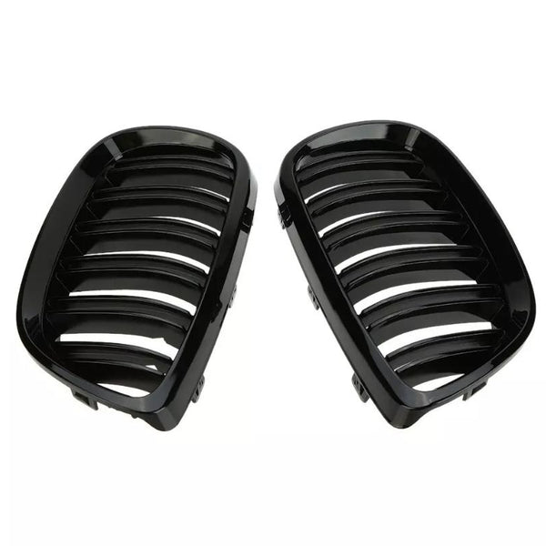 Two black, glossy car grilles with parallel slats are positioned side by side against a plain, white background, likely intended for vehicle front-end installation.