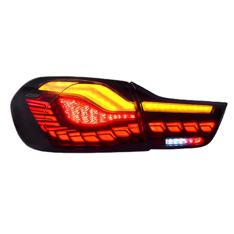 A car taillight emits bright red and amber light patterns. The angular, modern design is set against a plain, white background.