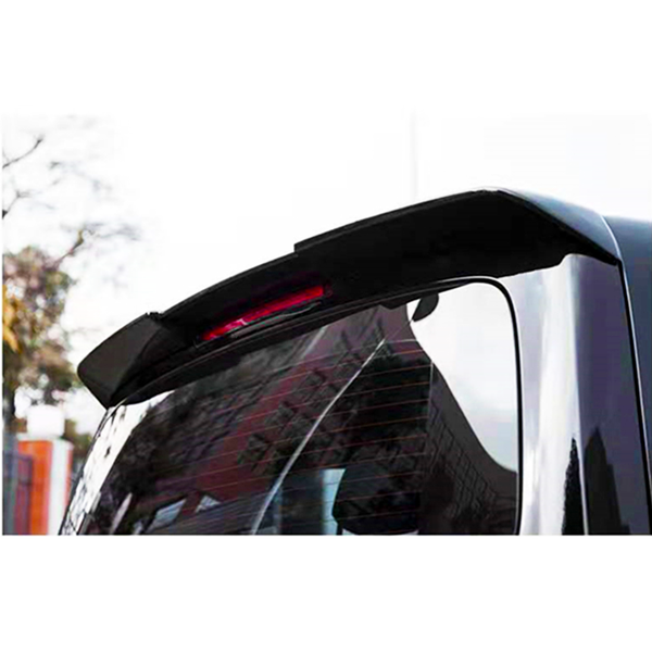 A car's rear window wiper is angled upward beneath a high-mounted brake light. Trees and buildings reflect off the window, indicating an outdoor setting.