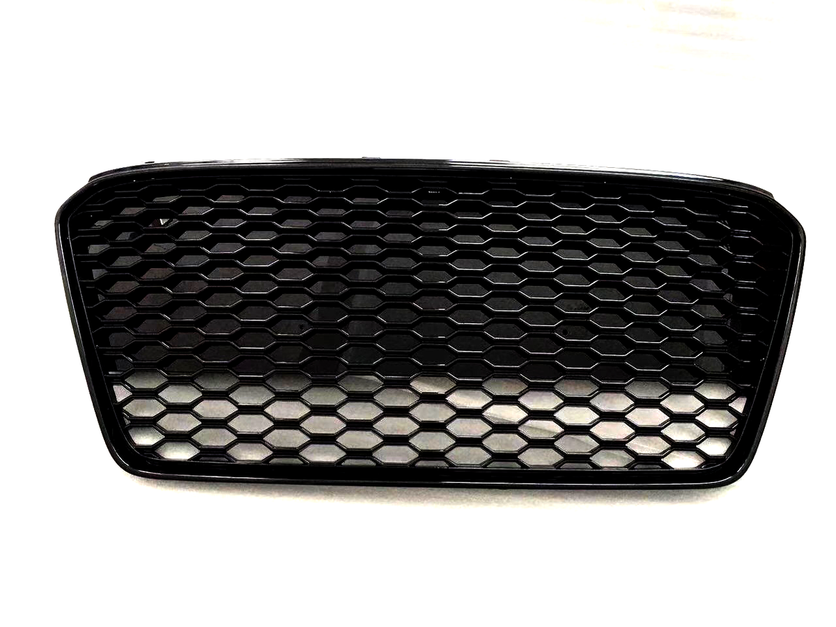 A black, hexagonal mesh car grille, positioned against a plain white background, showcases its open design. The structured pattern suggests it is part of a vehicle's front-end assembly.