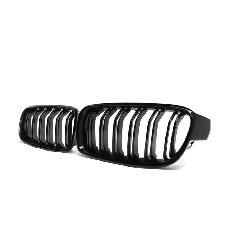 A black kidney grille with vertical slats, resting against a white background. It appears to be a component for a vehicle, possibly the front grille of a car.