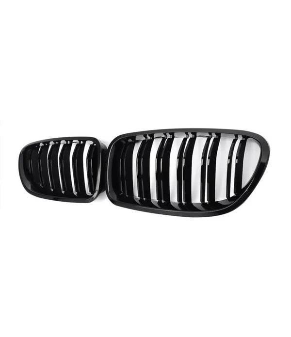 Black car kidney grille, featuring vertical slats, positioned against a white background.