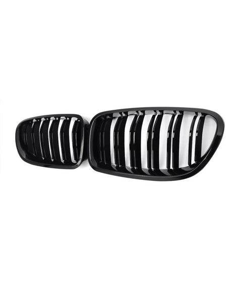 Black car kidney grille, featuring vertical slats, positioned against a white background.