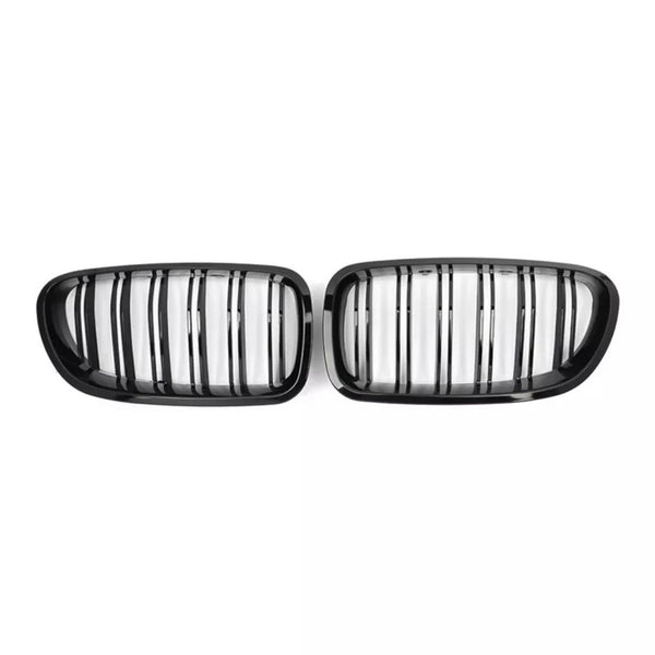 Two black, oval car grilles with vertical slats are positioned side by side against a plain white background.