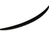 A single, black, curved object resembles a blade or tusk, positioned diagonally against a plain white background, suggesting a sleek and minimalist design.