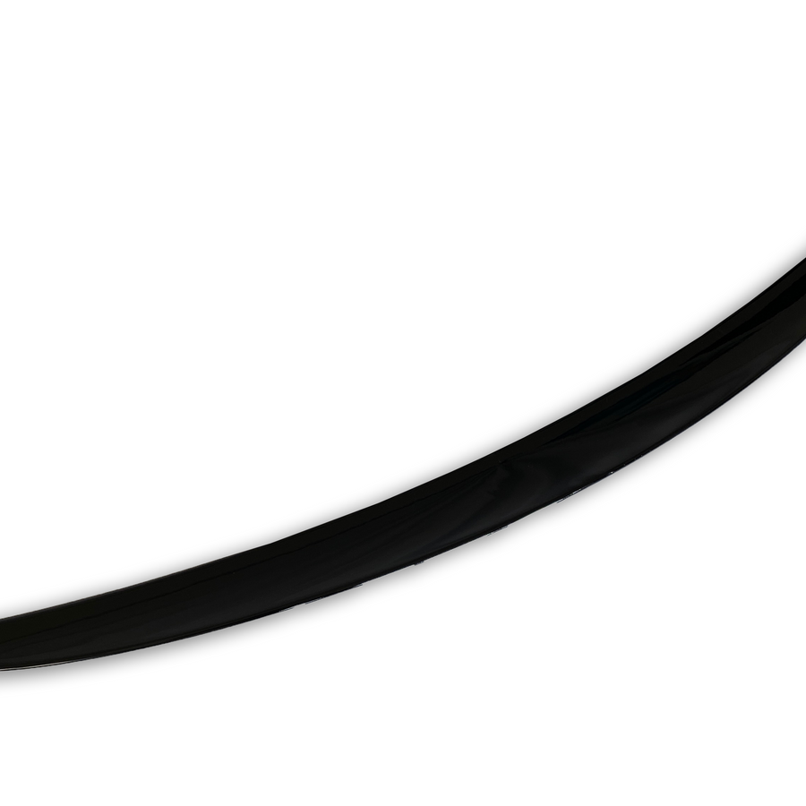 A single, black, curved object resembles a blade or tusk, positioned diagonally against a plain white background, suggesting a sleek and minimalist design.