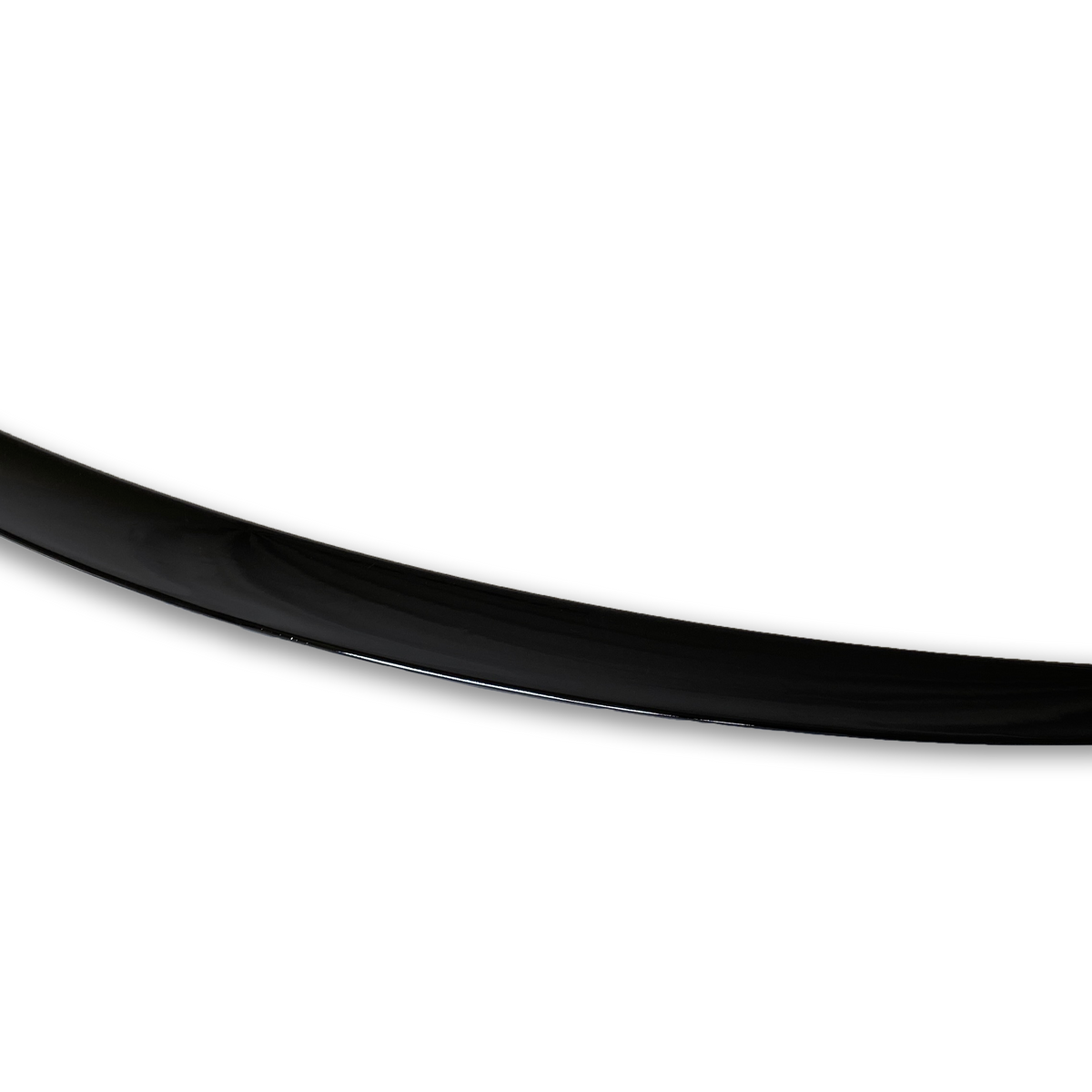 A sleek, elongated black object, resembling a boomerang or crescent shape, lies against a plain white background, its surface smooth and polished.