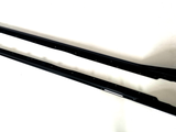 Two elongated black metal car side skirts lie parallel on a plain white surface, featuring multiple mounting holes along their length and slight contours for aerodynamic enhancement.