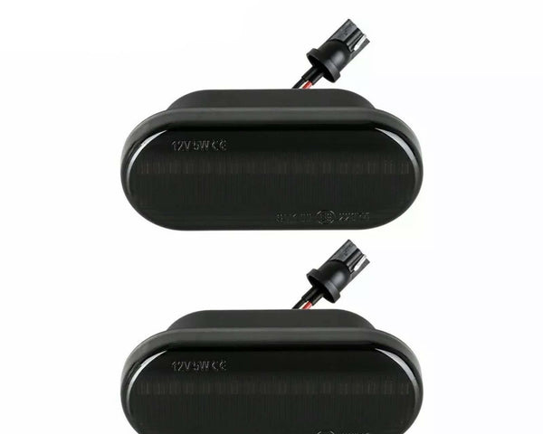 Two black rectangular automotive lights with connectors attached, displayed on a plain white background. Text on lights reads "12V 5W CE".