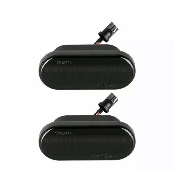 Two black rectangular automotive lights with connectors attached, displayed on a plain white background. Text on lights reads "12V 5W CE".