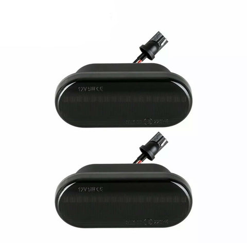 Two black rectangular automotive lights with connectors attached, displayed on a plain white background. Text on lights reads "12V 5W CE".