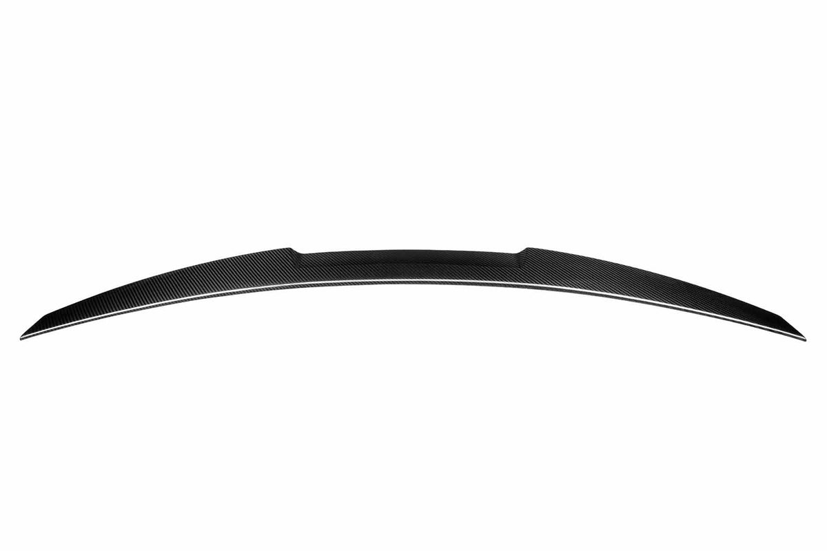 A black carbon fiber car spoiler, slightly curved, is suspended against a plain white background, showcasing its aerodynamic design.