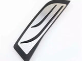 A sleek, curved, metallic car accessory with two slits rests on a plain white background, designed for aerodynamic enhancement.