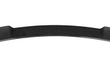 A black carbon fiber car spoiler rests horizontally against a plain white background, featuring a smooth, curved aerodynamic design.