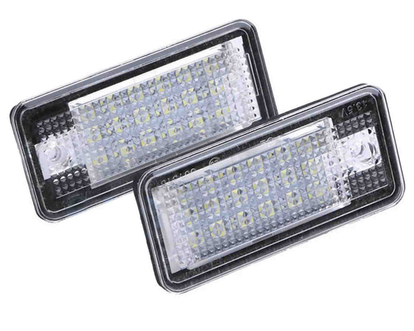 Two rectangular LED lights with a textured surface, positioned overlapping. The units are encased in clear plastic and set against a white background.