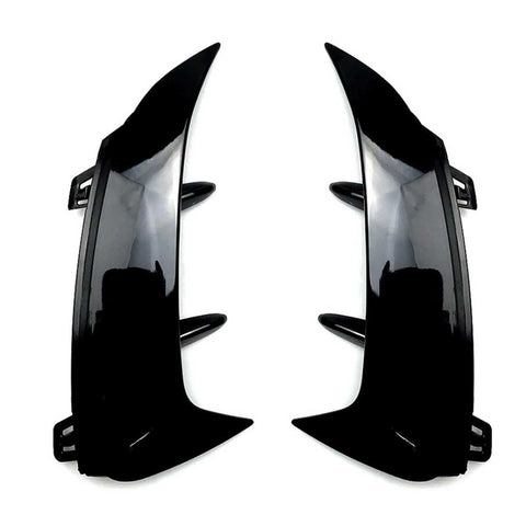 Two glossy black car bumper fins are facing each other, designed to be attached via clips. They are positioned on a plain white background.