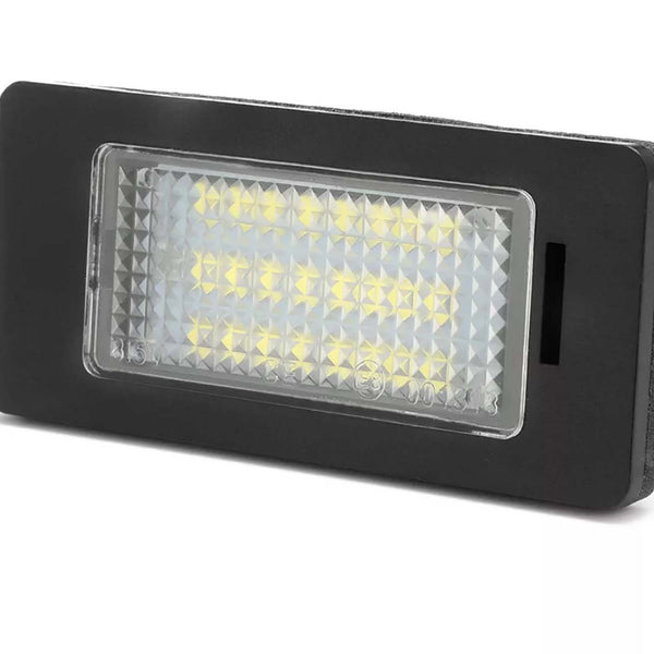 A rectangular LED light with a black frame, the LEDs illuminate through a textured lens. Set against a plain white background. Text on lens: “315, 101363.”