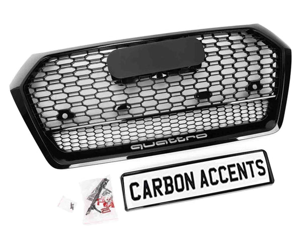 A hexagonal car grille with a honeycomb pattern labeled "quattro" includes mounting hardware. Below it, a framed sign reads "CARBON ACCENTS." The background is plain white.