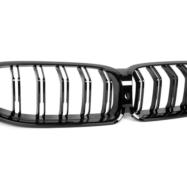 A glossy black dual-kidney car grille with vertical slats is positioned on a plain white background, highlighting its sleek, symmetrical design.