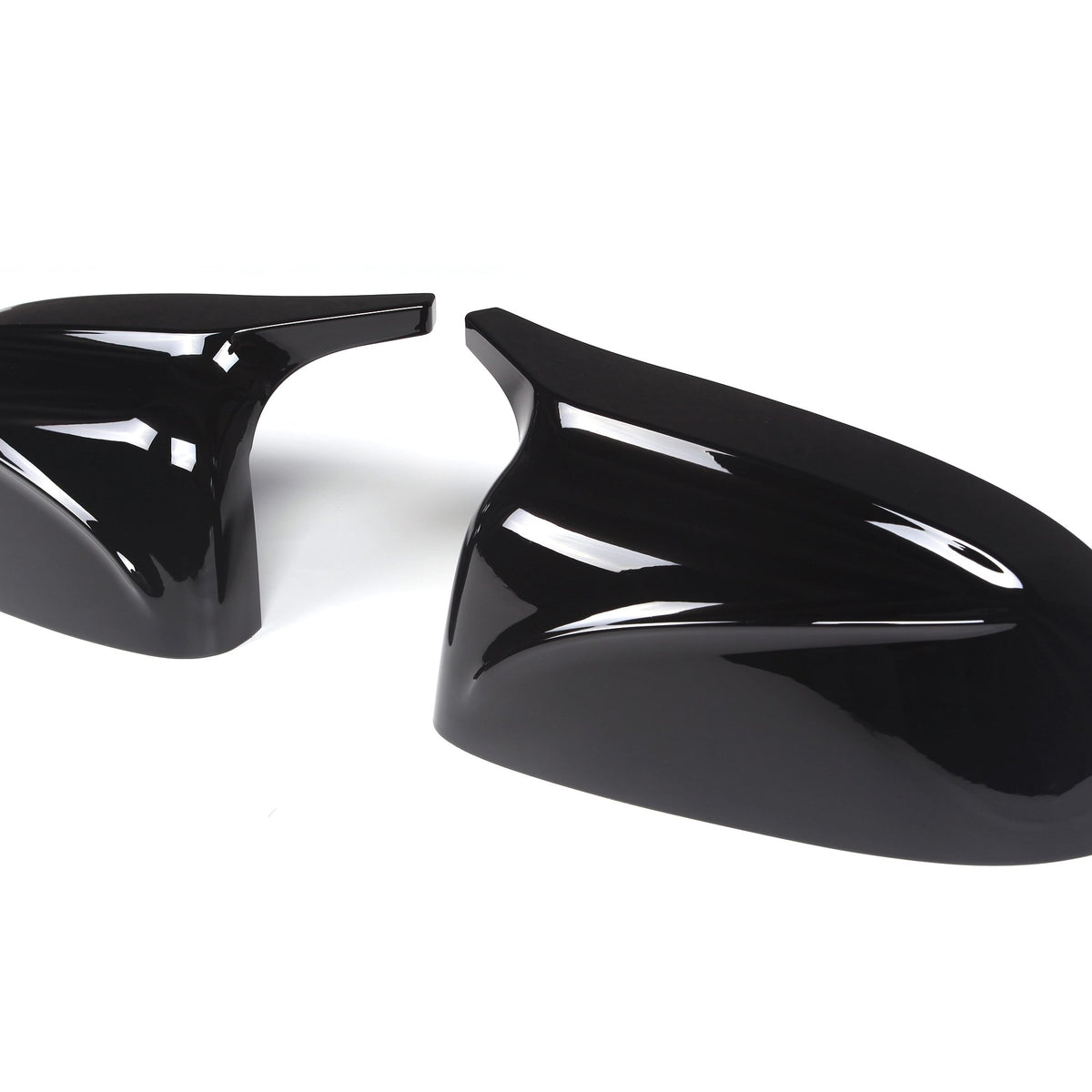 Two glossy black car mirror covers are positioned side by side on a white background. They are sleek and aerodynamic in design, intended for vehicle customization.
